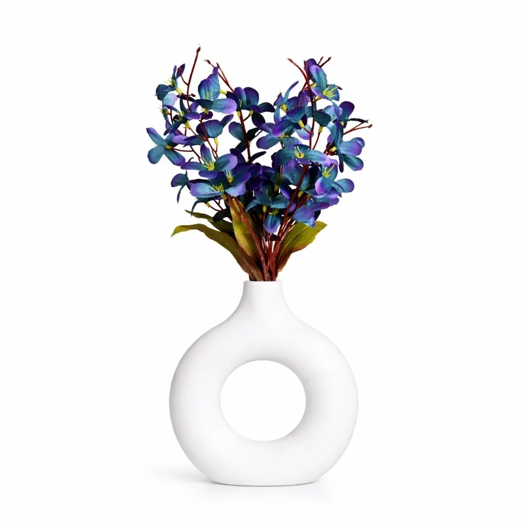 Artificial floral arrangement with white hollow plastic vase